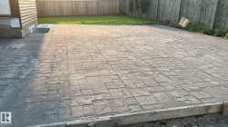 The property features an expansive stamped concrete patio with a textured pattern - 
