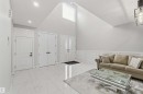 The property features high vaulted ceilings with a transom window providing natural light, recessed lighting, and white tile flooring - 1520 151 Avenue, Edmonton, AB  - Indoor 