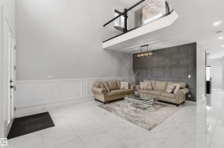 This living area features a high ceiling, white tile flooring, and wainscoting - 