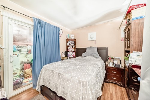 This room features wood-look flooring and a light-colored wall paint - 16305 107A Ave, Edmonton, AB - Indoor Photo Showing Bedroom