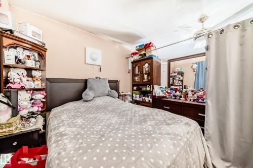 The room features a ceiling fan, a headboard, and light-colored walls - 16305 107A Ave, Edmonton, AB - Indoor Photo Showing Bedroom