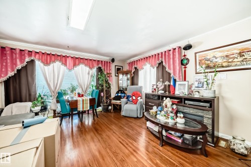 The interior features rich hardwood flooring and a skylight providing natural light - 16305 107A Ave, Edmonton, AB - Indoor