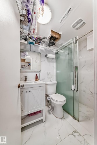 Bathroom featuring a vanity with white cabinetry, a toilet, and a glass-enclosed shower - 16305 107A Ave, Edmonton, AB - Indoor Photo Showing Bathroom