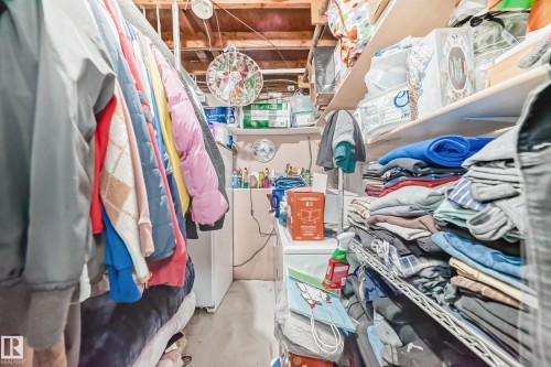 This area features exposed wooden ceiling beams and a white wall finish - 16305 107A Ave, Edmonton, AB - Indoor With Storage