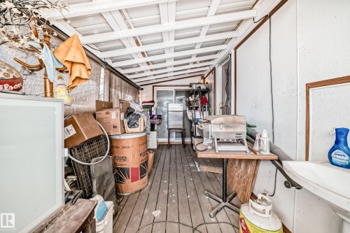 The property features an outdoor patio with a white slatted ceiling and wood flooring - 16305 107A Ave, Edmonton, AB - Indoor Photo Showing Other Room