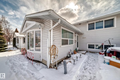The property features a light-colored exterior with a bay window and multiple windows, providing natural light - 16305 107A Ave, Edmonton, AB - Outdoor