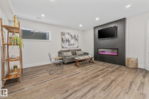 This living area features light-toned wood flooring and recessed lighting - 3864 Robins Crescent, Edmonton, AB - Indoor
