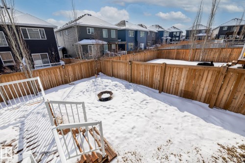 The property features a fenced backyard with a patio area and a fire pit - 3864 Robins Crescent, Edmonton, AB - Outdoor With Deck Patio Veranda