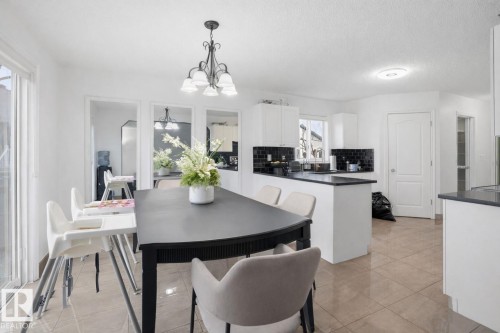 The property features a bright kitchen and dining area with white walls and a tiled floor - 4619 202 Street, Edmonton, AB - Indoor Photo Showing Dining Room