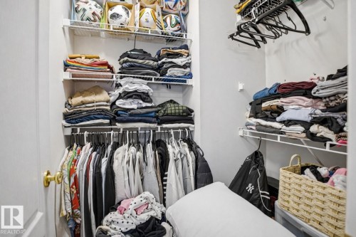 The closet features wire shelving and hanging rods for storage - 4619 202 Street, Edmonton, AB - Indoor With Storage