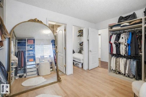 This room features light-toned flooring, built-in open shelving, and a large ornate mirror - 4619 202 Street, Edmonton, AB - Indoor