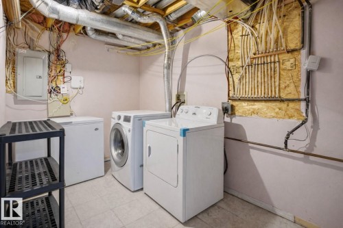 Dedicated laundry area featuring a washer, dryer, and an additional freezer - 4619 202 Street, Edmonton, AB - Indoor Photo Showing Laundry Room