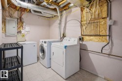 Dedicated laundry area featuring a washer, dryer, and an additional freezer - 