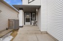 The property entrance features a covered porch with a white pillar and steps - 4619 202 Street, Edmonton, AB  - Outdoor With Exterior 