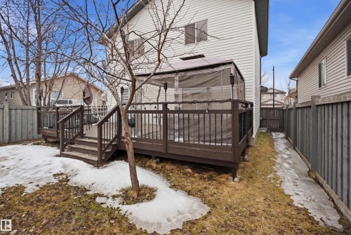 The property features an extensive deck with railings, an outdoor shelter, and exterior lighting - 4619 202 Street, Edmonton, AB - Outdoor