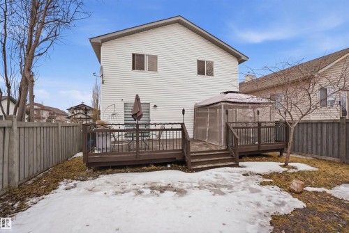 The property features a brown wooden deck with white string lights and a gazebo - 4619 202 Street, Edmonton, AB - Outdoor With Deck Patio Veranda With Exterior