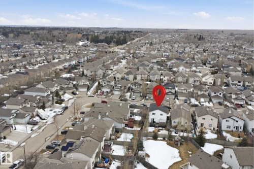 This property is situated within a well-established residential area, characterized by numerous houses with pitched roofs and a mix of paved roads and natural surroundings - 4619 202 Street, Edmonton, AB - Outdoor With View