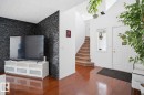 Entryway featuring hardwood flooring, a white front door with a window, and a carpeted staircase - 4619 202 Street, Edmonton, AB  - Indoor Photo Showing Other Room 