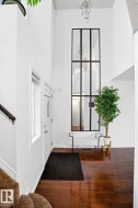 The property features high ceilings, hardwood flooring, and a decorative chandelier - 