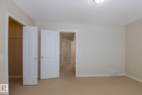 Room featuring neutral wall colors, carpeted floors, and white trim - 58 Birchmont Drive, Leduc, AB - Indoor Photo Showing Other Room