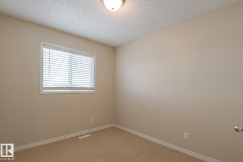 Bedroom featuring neutral colored walls and carpet flooring - 58 Birchmont Drive, Leduc, AB - Indoor Photo Showing Other Room