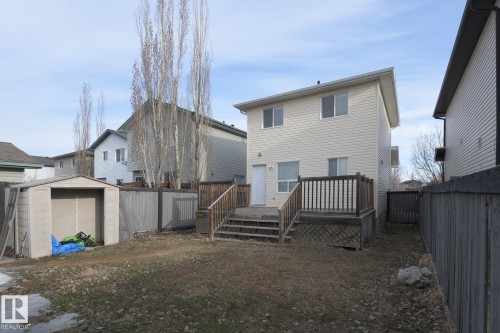The property features a private yard with a shed and a wooden deck - 58 Birchmont Drive, Leduc, AB - Outdoor