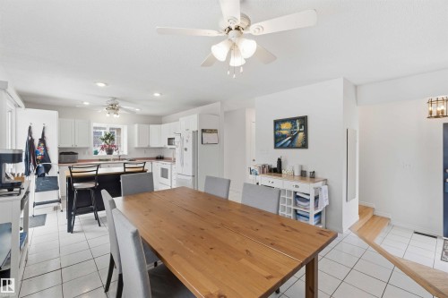This bright and open space features white tile flooring and white walls, creating a welcoming atmosphere - 4023 86 Street Nw, Edmonton, AB - Indoor