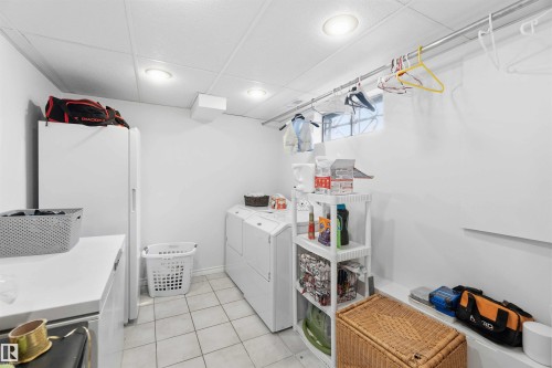 Utility area with white walls, recessed lighting, and tile flooring - 4023 86 Street Nw, Edmonton, AB - Indoor Photo Showing Laundry Room