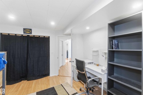 This room features hardwood flooring, white walls, and recessed lighting - 4023 86 Street Nw, Edmonton, AB - Indoor Photo Showing Office