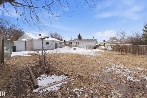 The property features an extensive yard with areas of snow cover and visible fencing - 4023 86 Street Nw, Edmonton, AB - Outdoor