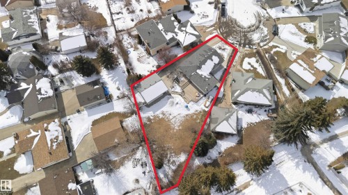 Aerial view of the property and its surrounding neighborhood, featuring a large yard and nearby residences - 4023 86 Street Nw, Edmonton, AB - 