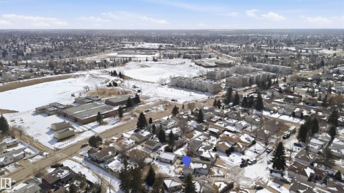 Aerial view of the surrounding neighborhood, featuring residential properties, commercial structures, and open land areas - 4023 86 Street Nw, Edmonton, AB - Outdoor With View