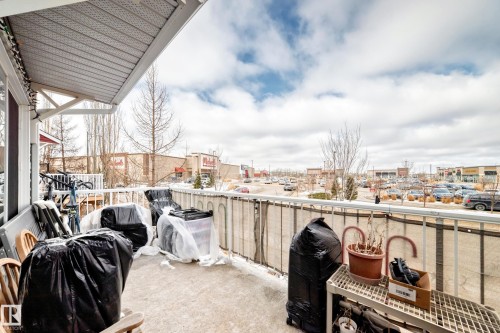 The property features an exterior balcony with a railing and an awning, offering views of the surrounding area - 138 655 Tamarack Road Nw, Edmonton, AB - Outdoor With Balcony
