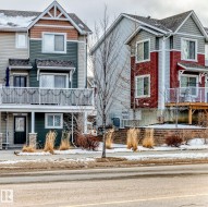 The property features a two-story exterior with a balcony, a front entry door, and visible windows - 
