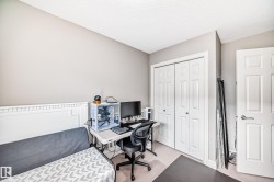 This room features light-colored walls and carpeting, with white trim and doors - 