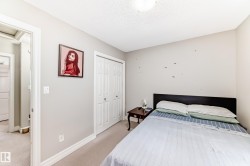 This room features light-colored walls and carpeted flooring - 