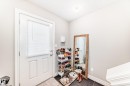 Entryway with a white paneled door and dark flooring - 138 655 Tamarack Road Nw, Edmonton, AB  - Indoor Photo Showing Other Room 