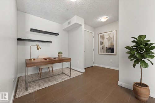 The property features an entryway with brown tile flooring and light-colored walls - 301 1070 Mcconachie Boulevard, Edmonton, AB - Indoor Photo Showing Office