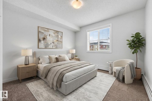 The bedroom features light-colored walls, a window with blinds, and carpeted flooring - 301 1070 Mcconachie Boulevard, Edmonton, AB - Indoor Photo Showing Bedroom