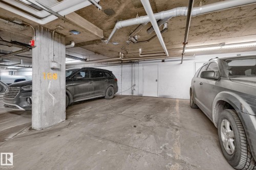 Underground parking space with a concrete floor and a concrete support column - 301 1070 Mcconachie Boulevard, Edmonton, AB - Indoor Photo Showing Garage