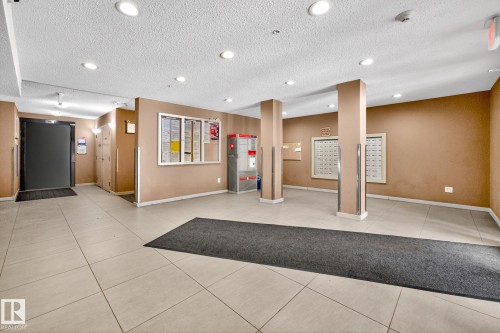 Entryway with light-toned tiled flooring, recessed lighting, and mailboxes - 301 1070 Mcconachie Boulevard, Edmonton, AB - Indoor Photo Showing Other Room