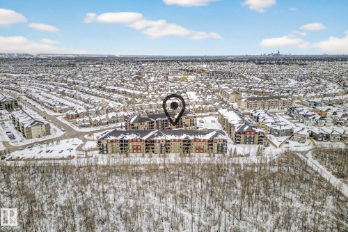 Aerial view of the property and surrounding neighborhood, featuring multi-story residential buildings with contrasting facades - 301 1070 Mcconachie Boulevard, Edmonton, AB - Outdoor With View