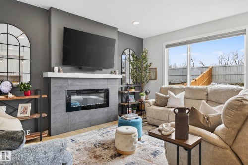 139 Stonehouse Way, Leduc, AB - Indoor Photo Showing Living Room With Fireplace