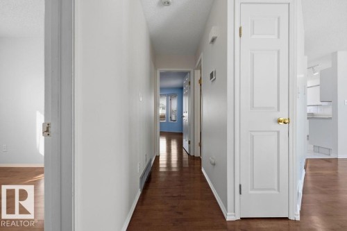 Hallway featuring hardwood floors and white paneled doors - 3772 30 Street, Edmonton, AB - Indoor Photo Showing Other Room