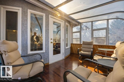 The property features a sunroom with a clear, curved roof and large windows, offering abundant natural light - 3772 30 Street, Edmonton, AB -  With Deck Patio Veranda With Exterior
