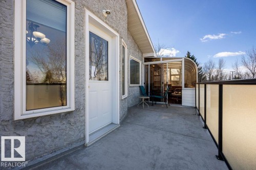 The property features an exterior with textured siding, a white entry door, and white-framed windows - 3772 30 Street, Edmonton, AB - Outdoor With Exterior