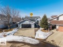The property features a two-car garage with a black door, a paved driveway, and a welcoming arched entryway - 3772 30 Street, Edmonton, AB  - Outdoor 