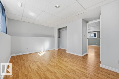 Bright room featuring light wood flooring, light grey walls, and a recessed ceiling light - 3772 30 Street, Edmonton, AB - Indoor Photo Showing Other Room