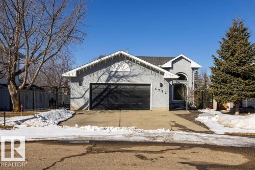 The property features a stucco exterior, an attached garage, and a paved driveway - 3772 30 Street, Edmonton, AB - Outdoor
