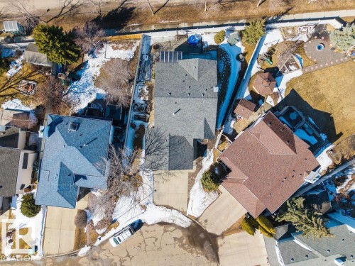 Aerial view of the property, showcasing its paved driveway, gray shingle roof, and surrounding landscaping - 3772 30 Street, Edmonton, AB - Outdoor